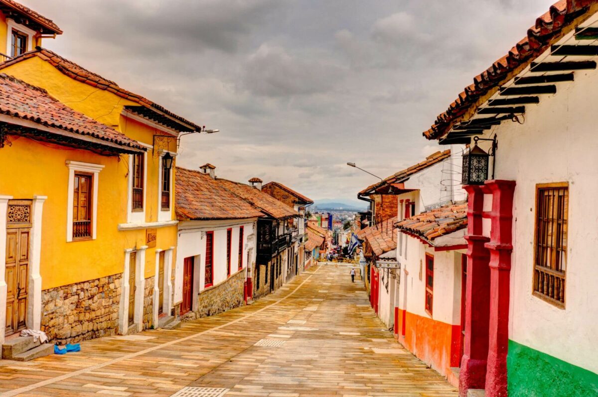 La Candelaria street - a hostorical street in Bogota with colorful terraced houses on both sides of a narrow paved street
