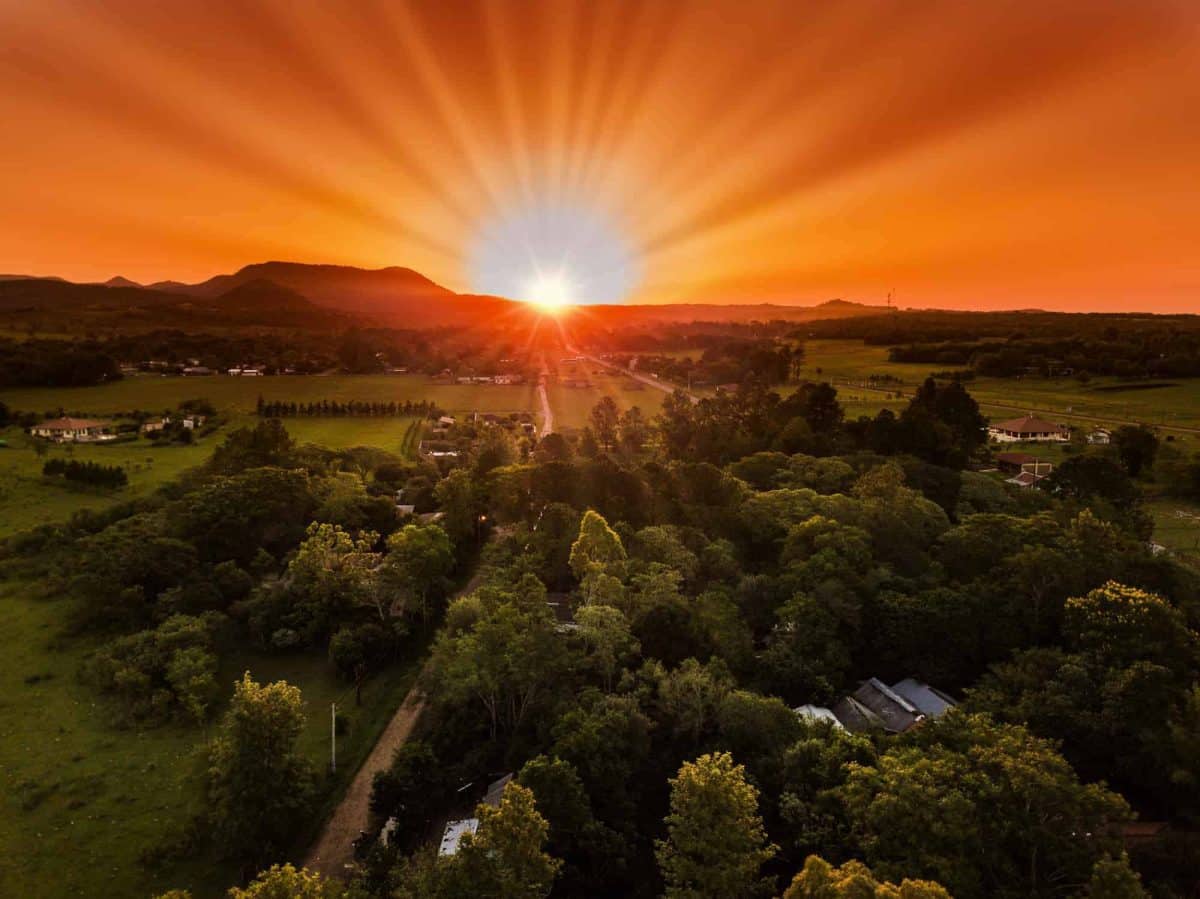 Sun setting down in Paraguay - golden skies above a vast green forst