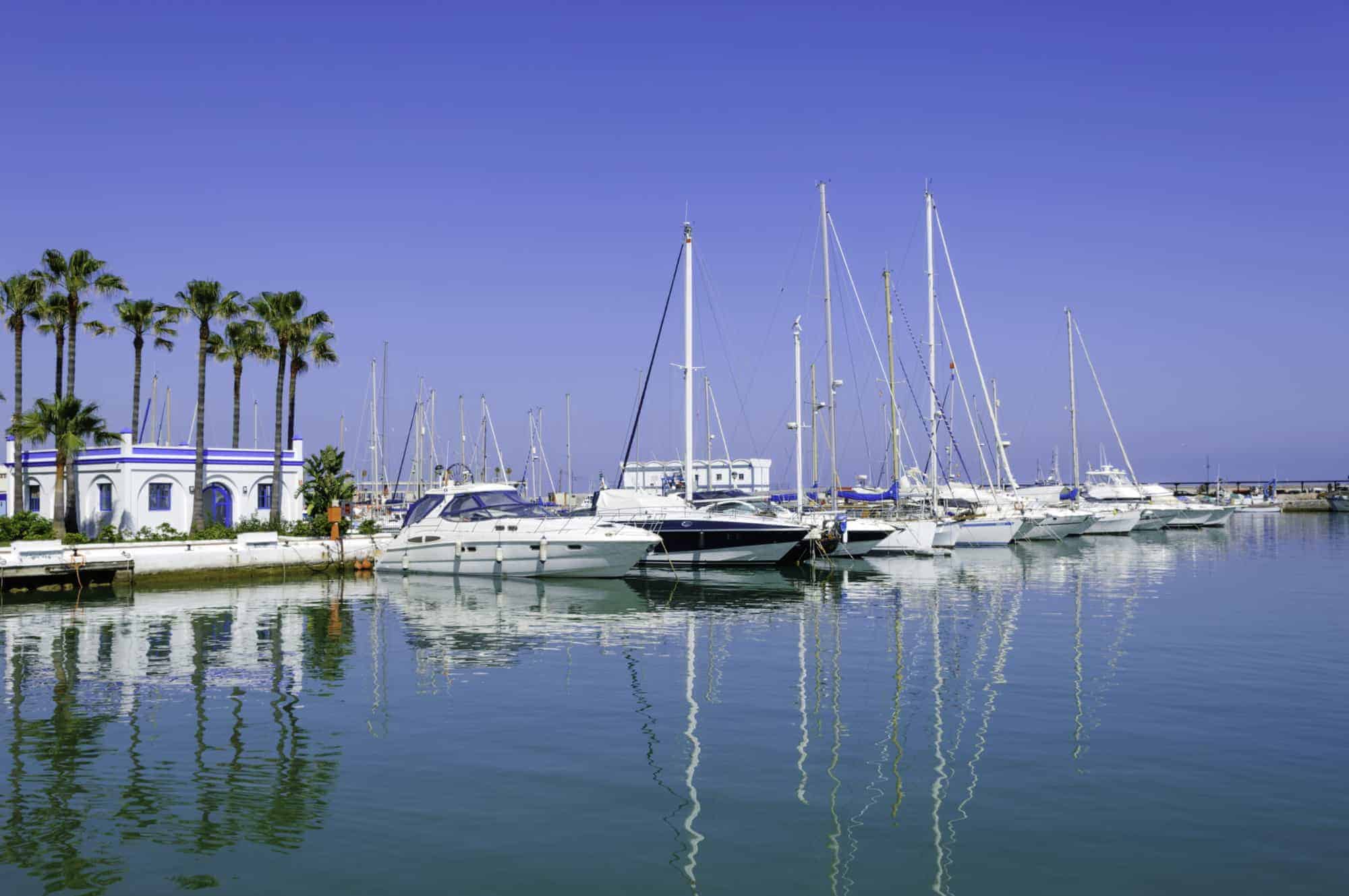 The marina in Estepona in summer, luxury yachts, bars and restaurants along the water.