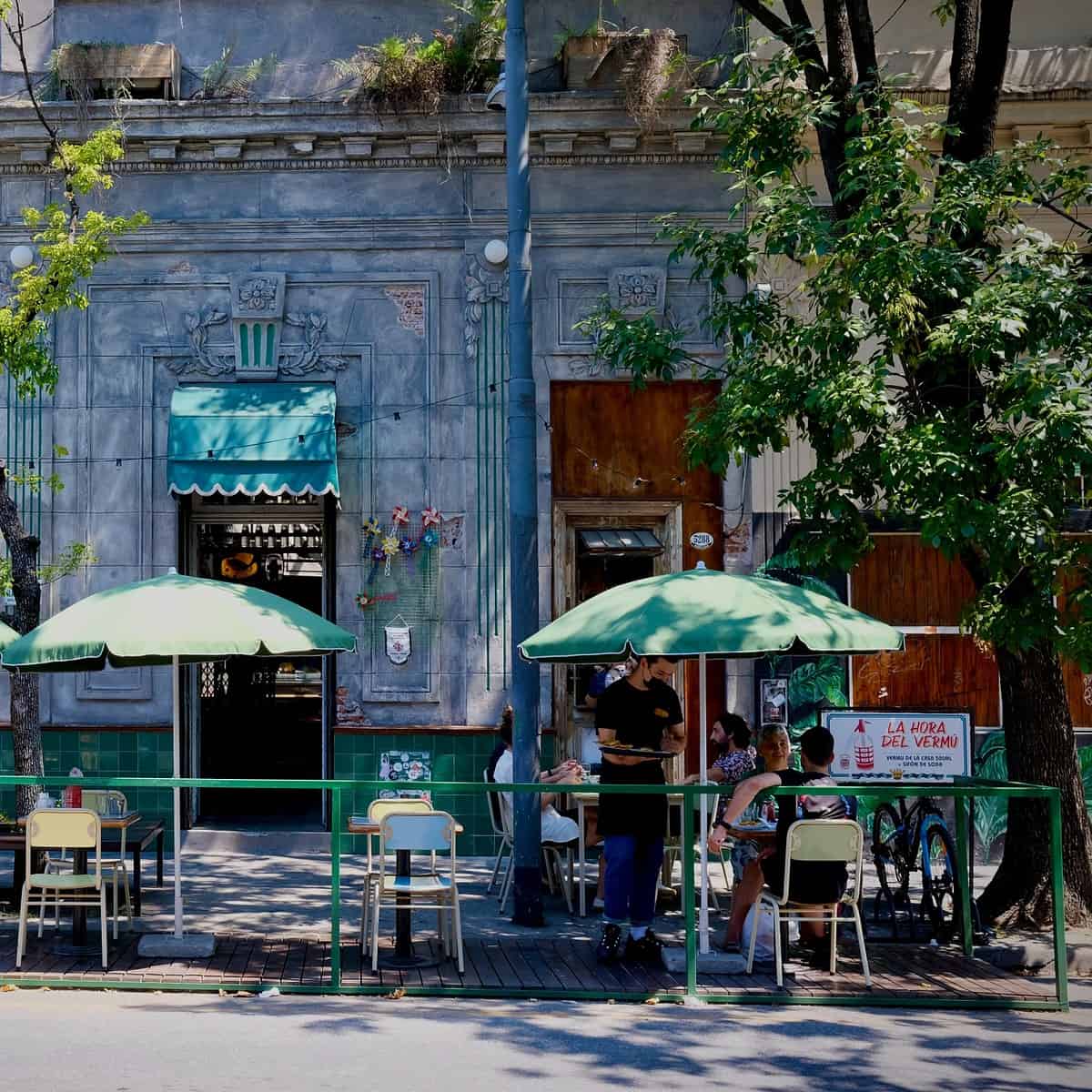 A street cafe in Palermo, Buenos Aires - people sitting outside drinking coffee, one of the best neighborhoods to live in Buenos Aires
