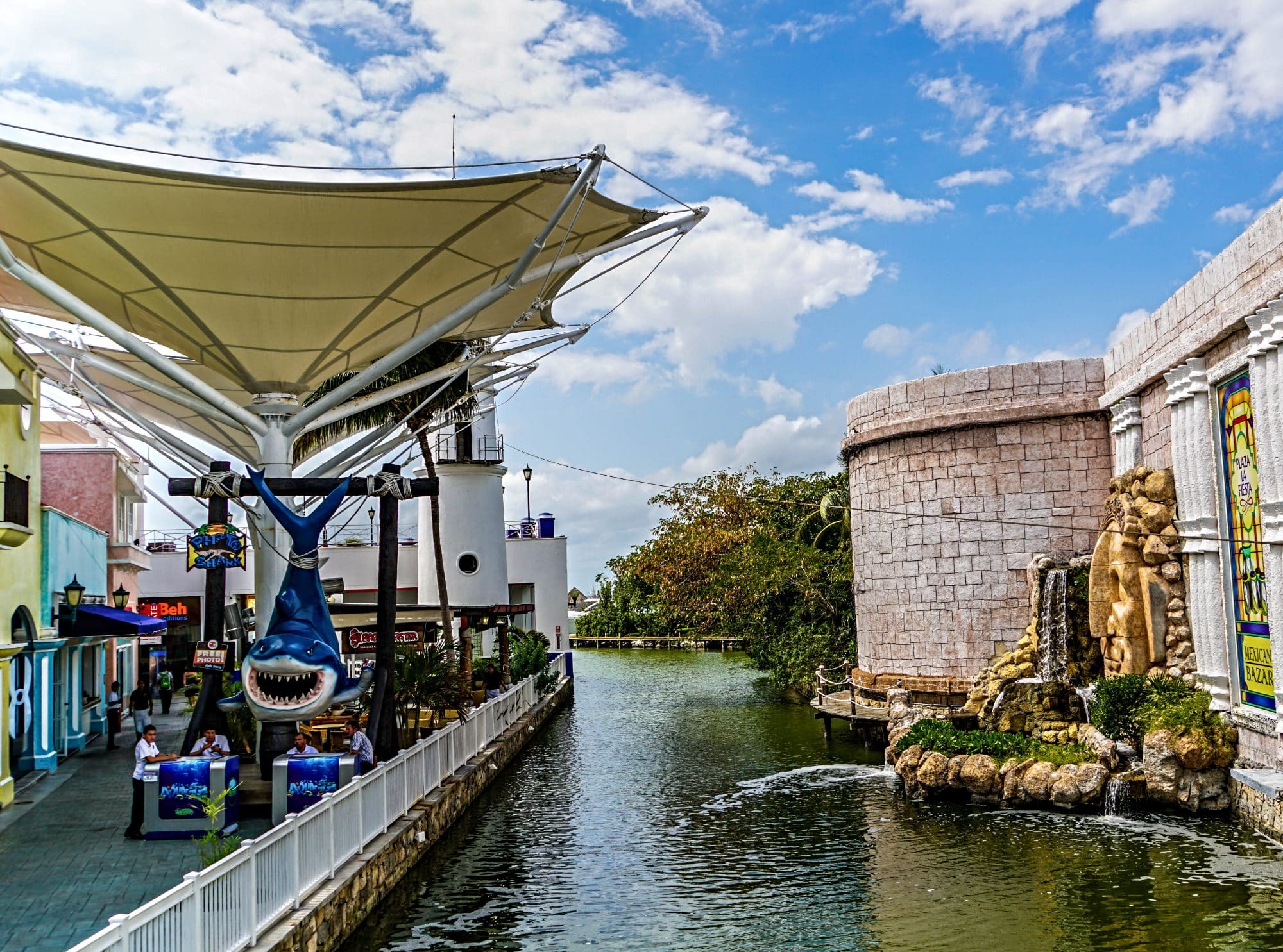 An open air shopping mall in Cancun with a canal and pretty streets and passages hosting boutiques and shops