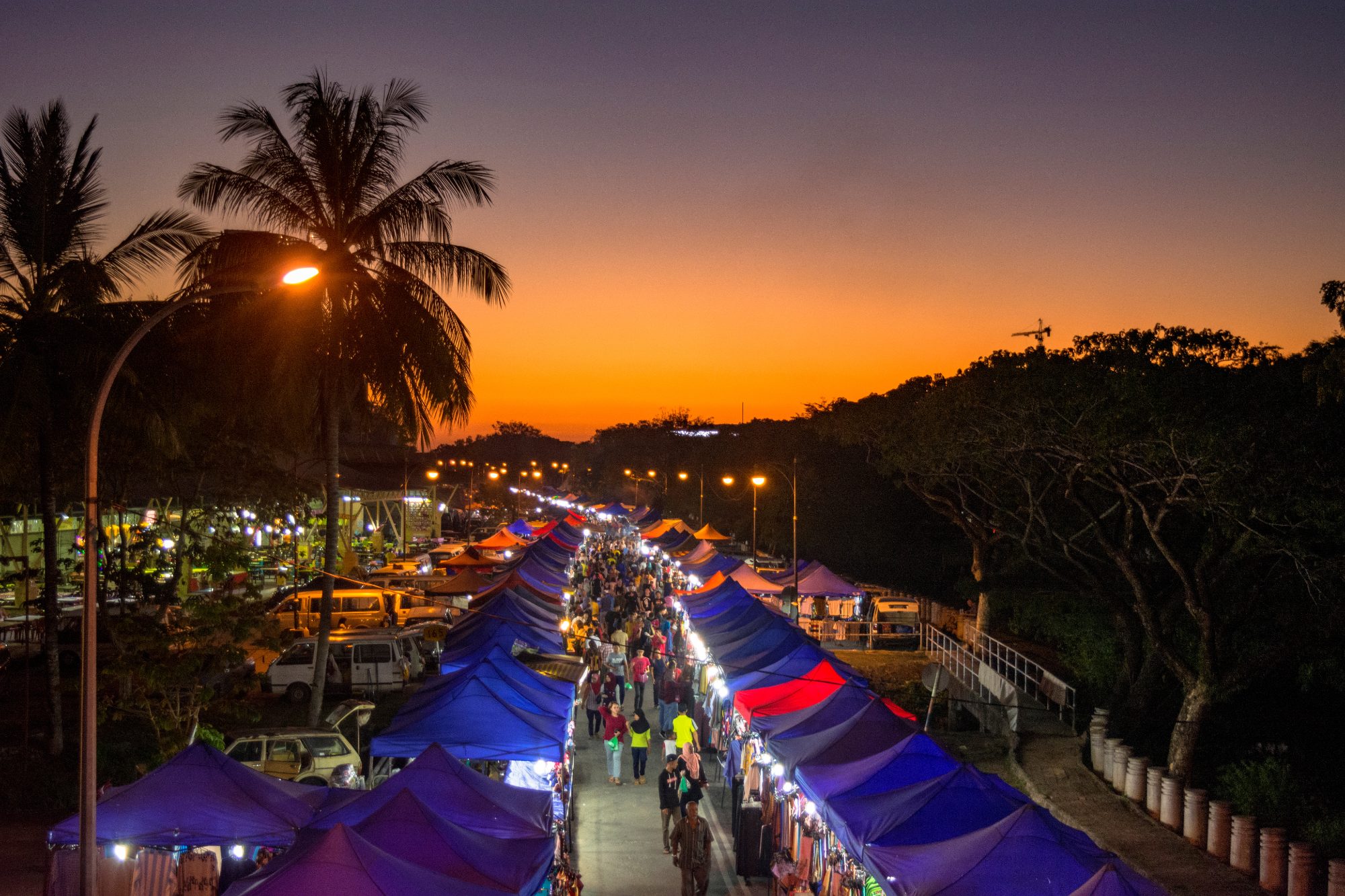 A long row of stalls and bright lights of Langkawi night market in Malaysia