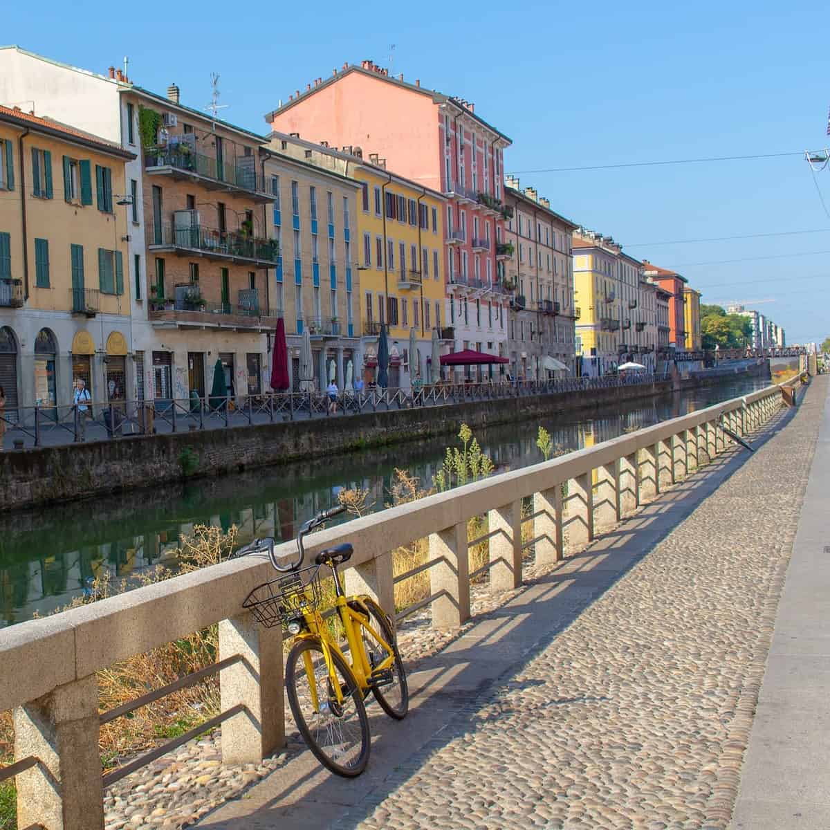A city canal flanked by beautiful old buildings in Navigli, Milan