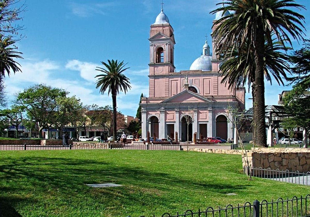 Maldonado, San Fernando Square - a green space with tall palm trees, and historical buildings.