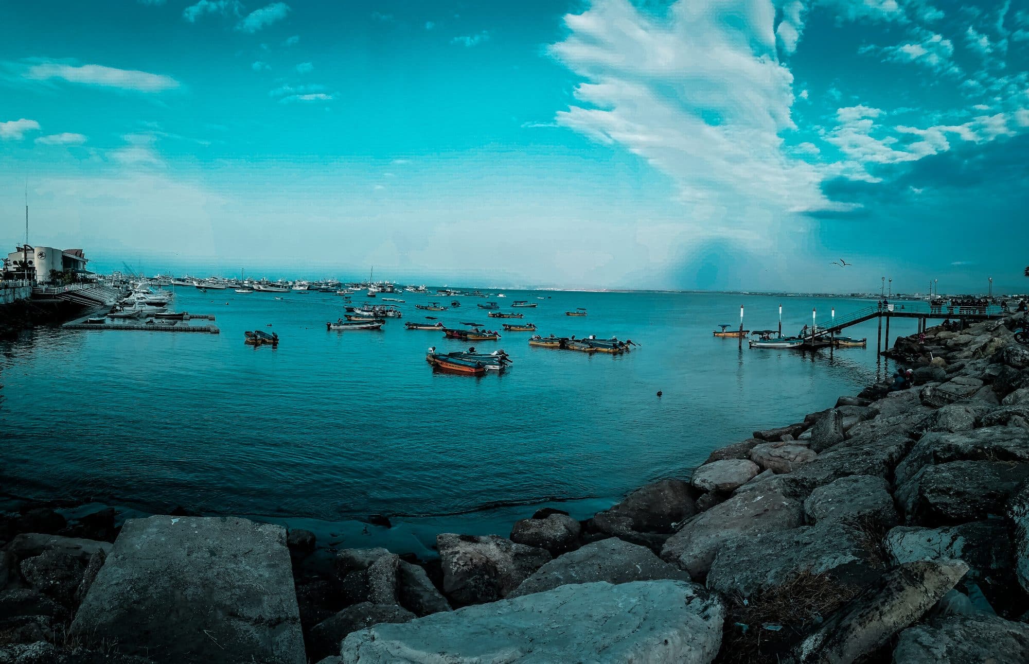 A moody image of Manta seaside in the twighlight with boats on the water