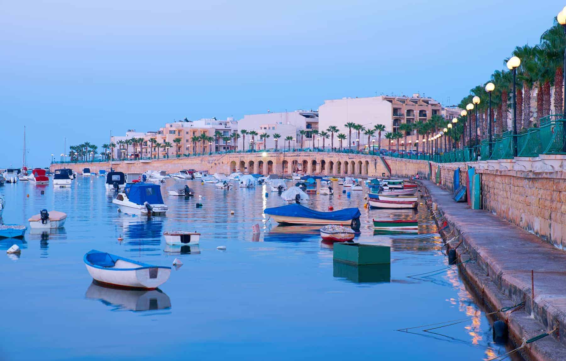 Stunning Marsaskala waterfront with traditional Maltese fishing boats sheltered for the night, Malta