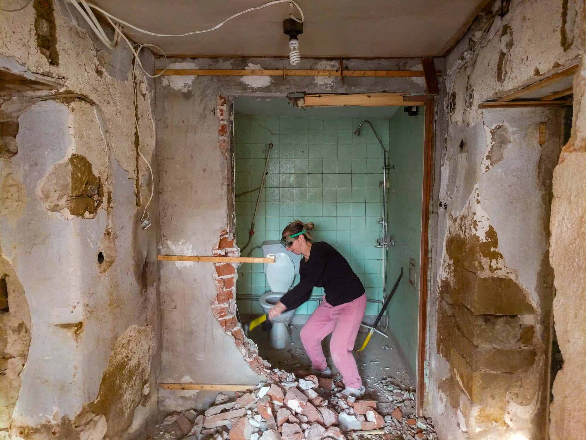 The renovation process: Emily is knocking out a wall.