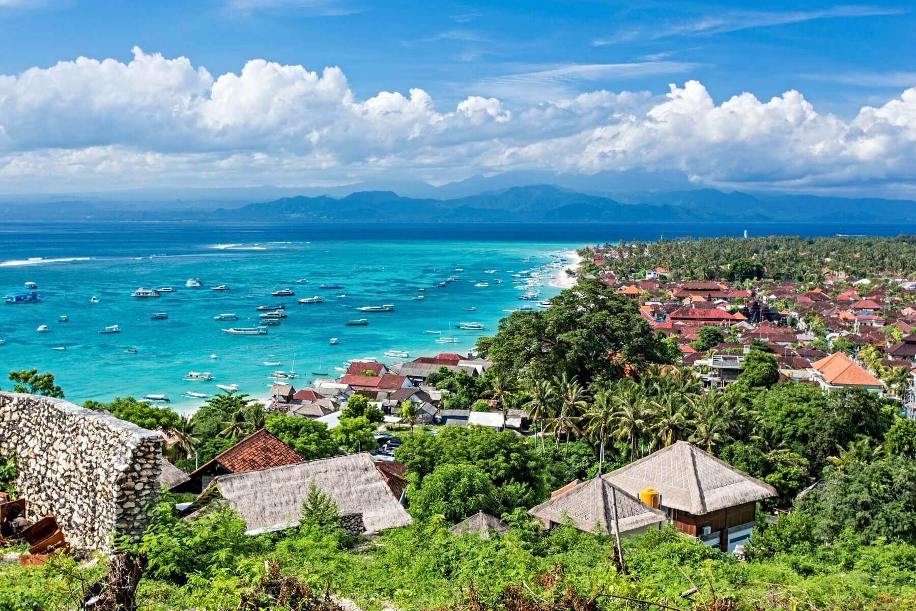roofs of a tropical village on an island next to Bali facing the sea