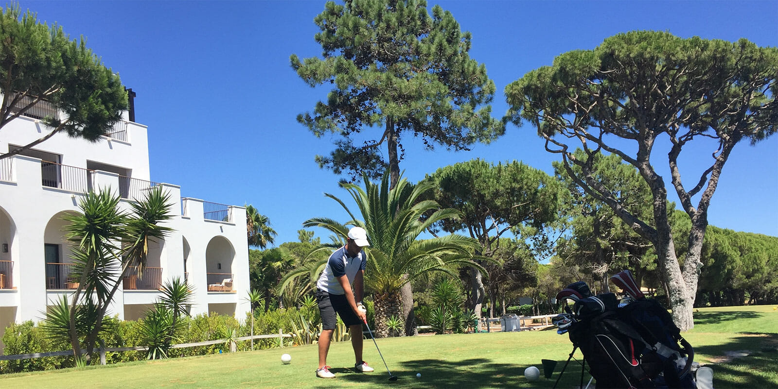 A person playing golf on a sunny day