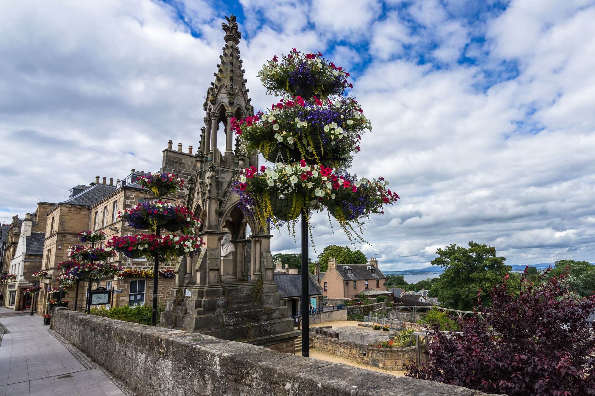 A pretty historic street in the town of Tain in Scotland featuring old buildings and a park