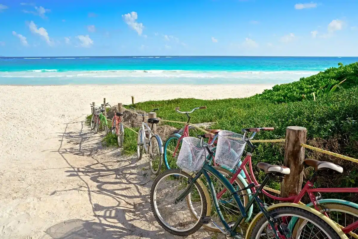 Bikes parked by the sandy beach in Tulum, Mexico